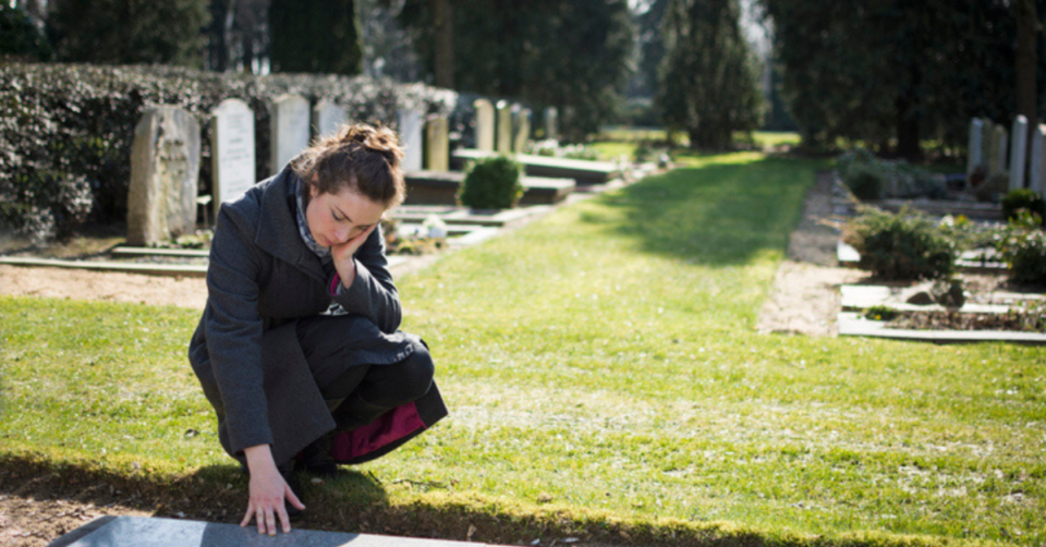 a woman at a grave