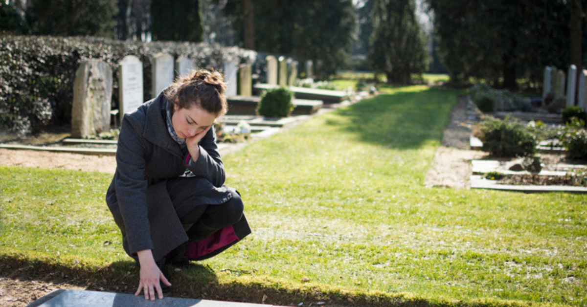 a woman at a grave