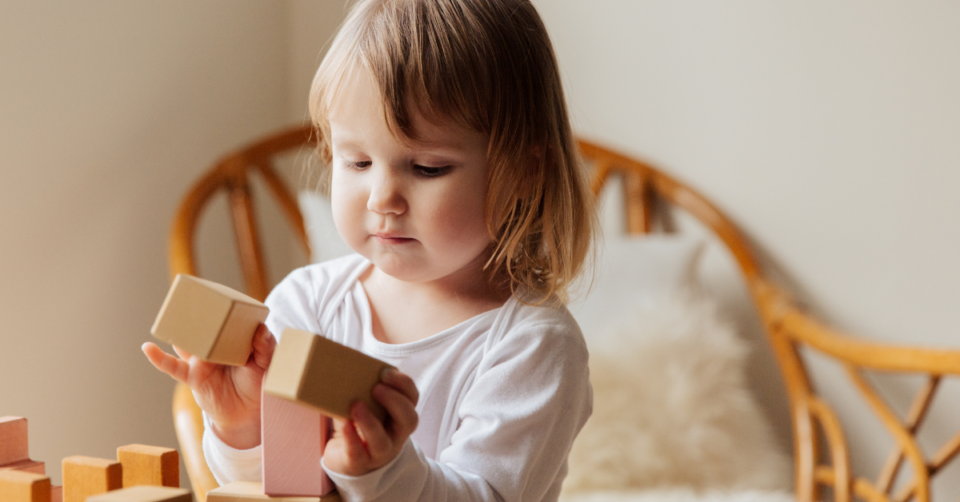 a child holding bricks
