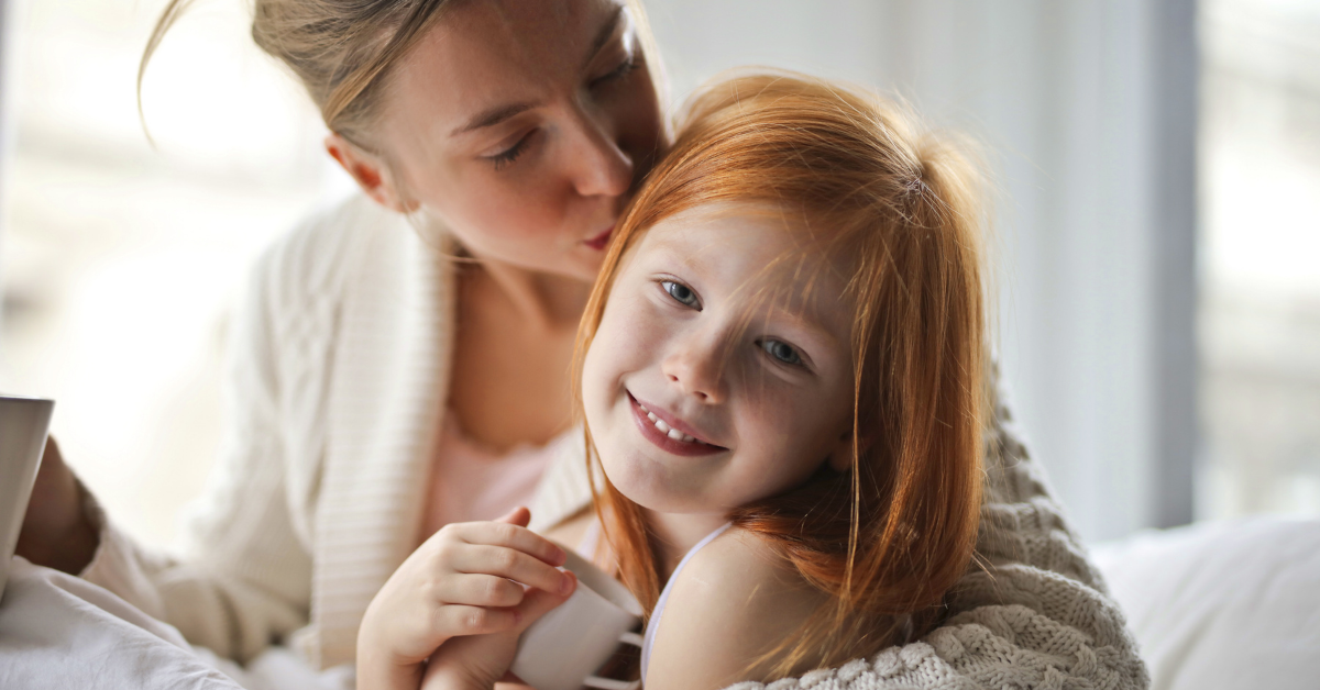 a mum and girl hugging