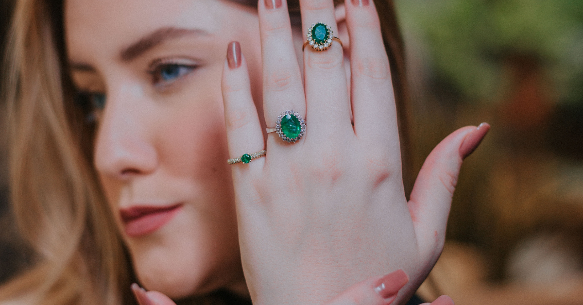 a lady wearing emerald jewellery