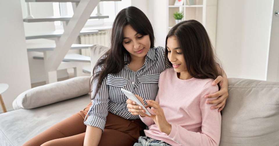 mum and teen looking on their phone