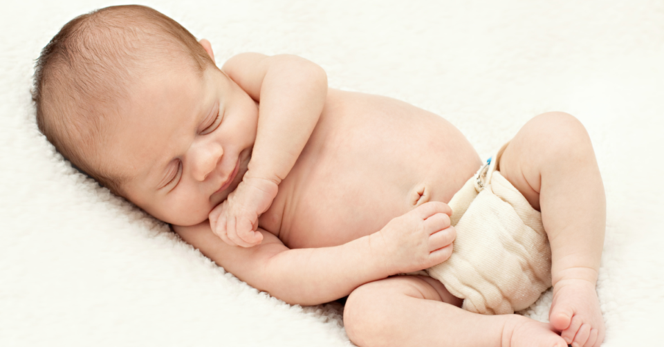 a newborn baby in a reusable nappy