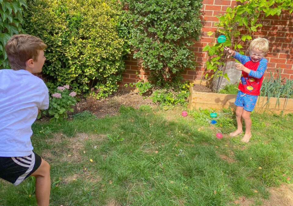 the boys throwing the Soppycid reusable water balloons