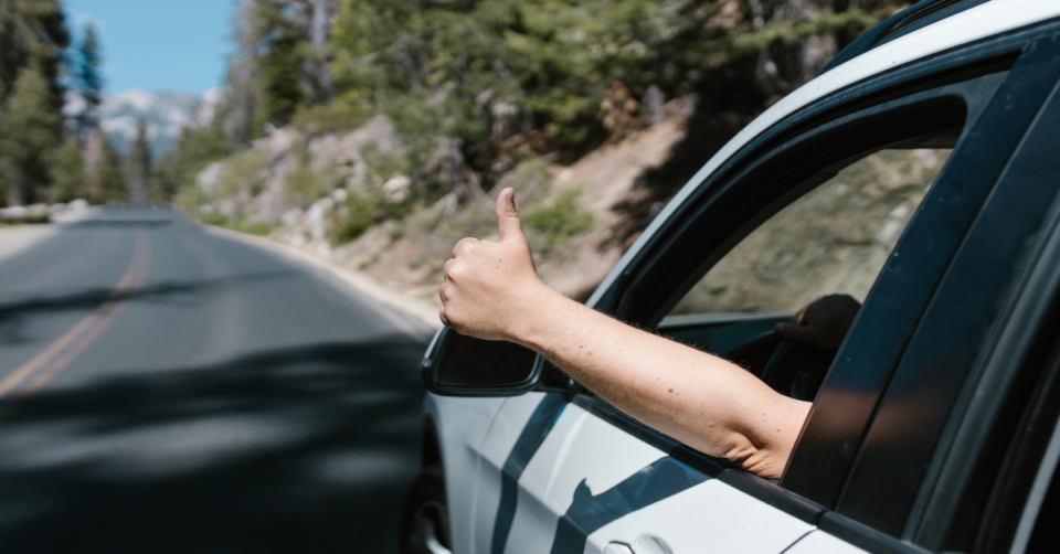 thumbs up out of a car window