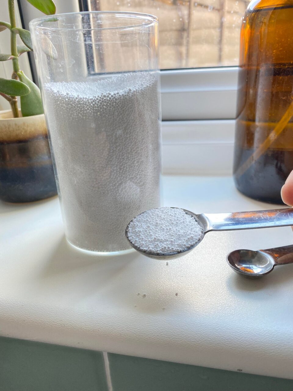 the Percarbonate of Soda being shown in a tablespoon