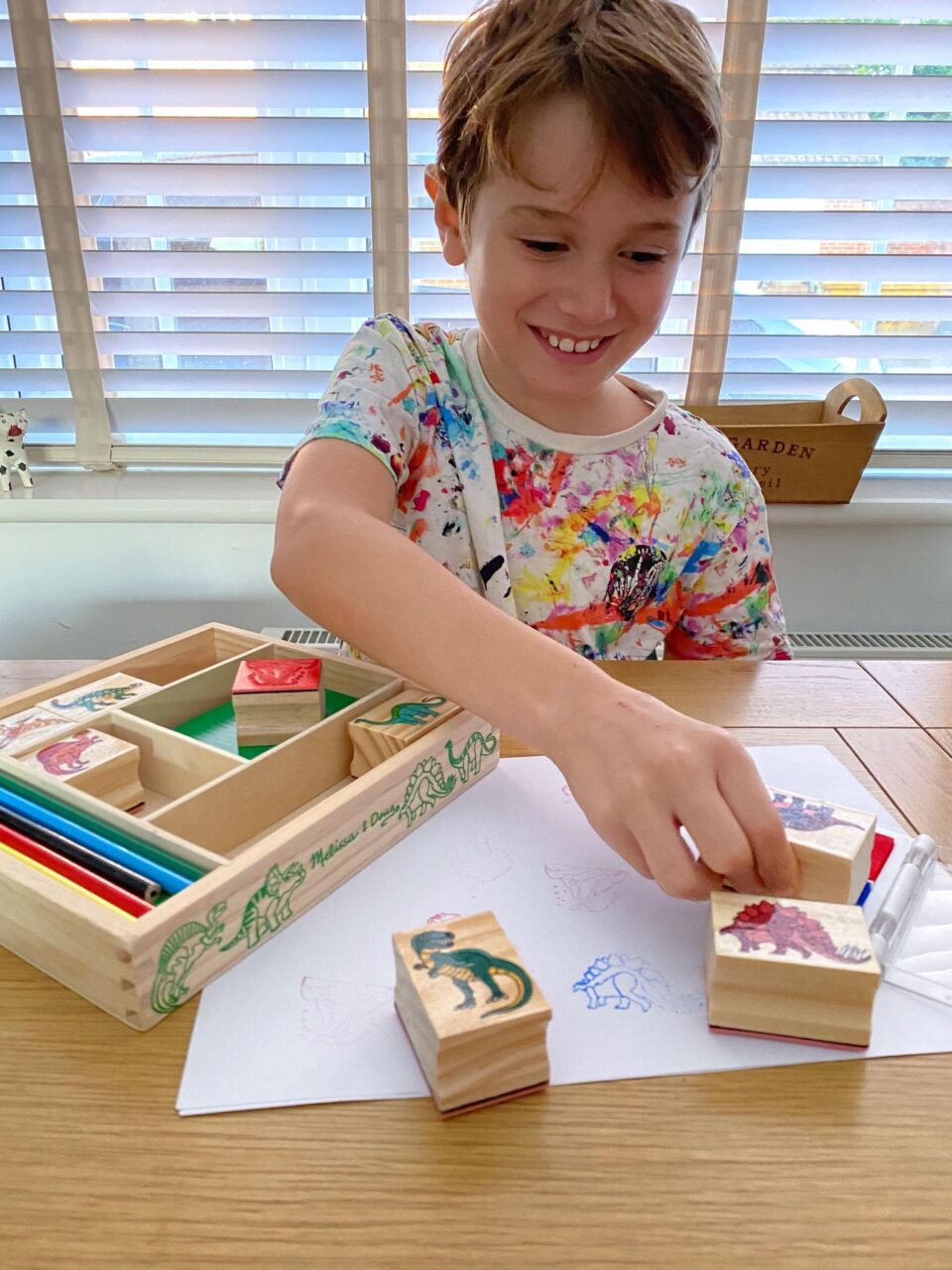 Jake playing with the dinosaur stamps