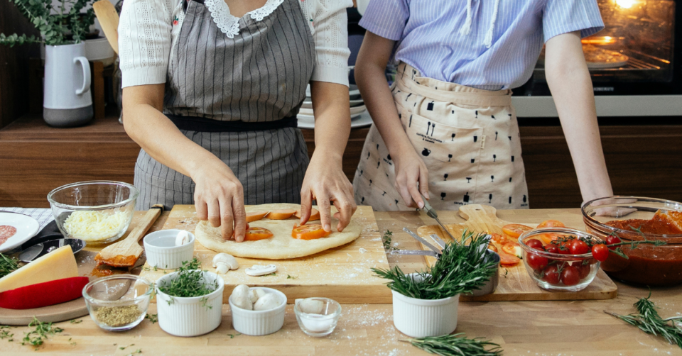 two people cooking