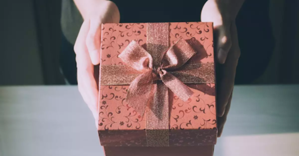 pink gift box being held out