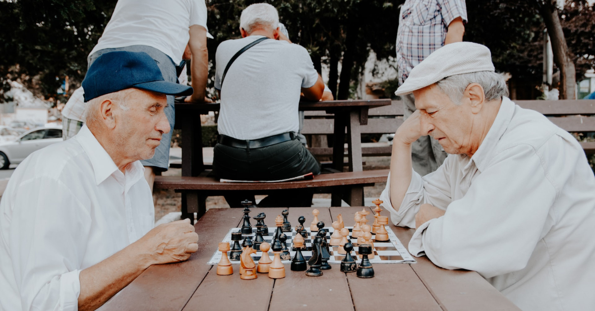 senior men playing chess