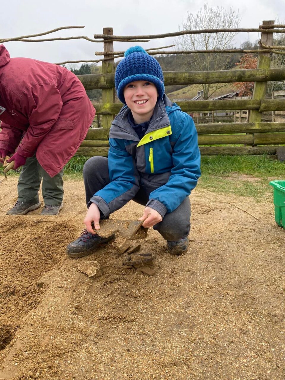 my son showing what he found in the dig