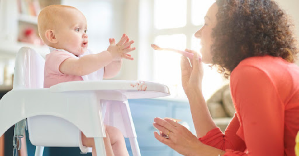 mum feeding her baby organic baby food