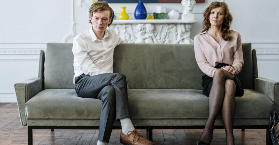 2 people sitting on a sofa