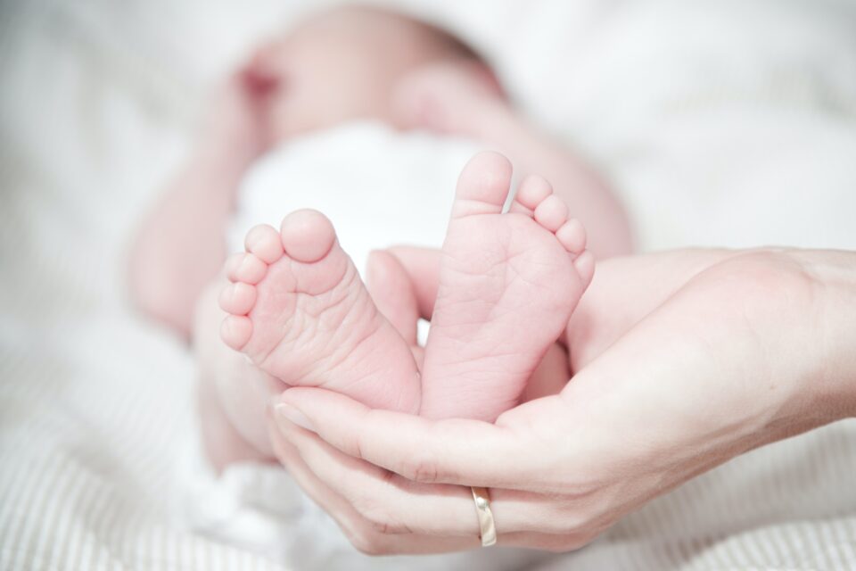 a newborn baby's feet being held