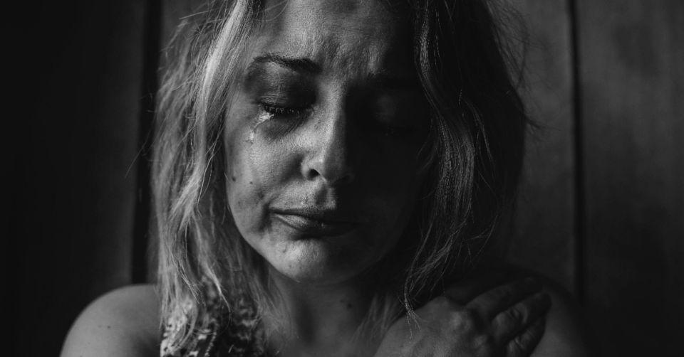 black and white photo of a woman crying