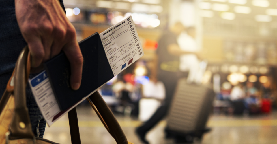 passport and boarding pass in someones hand