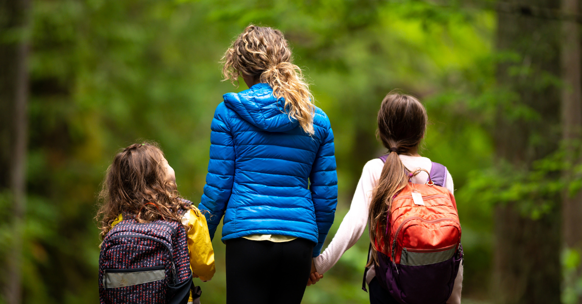 mum and 2 kids on a walk in a forest