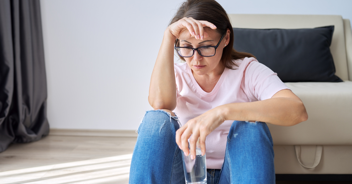 a woman sat on the floor having a hot flash