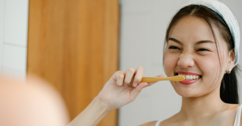 a lady brushing her teeth