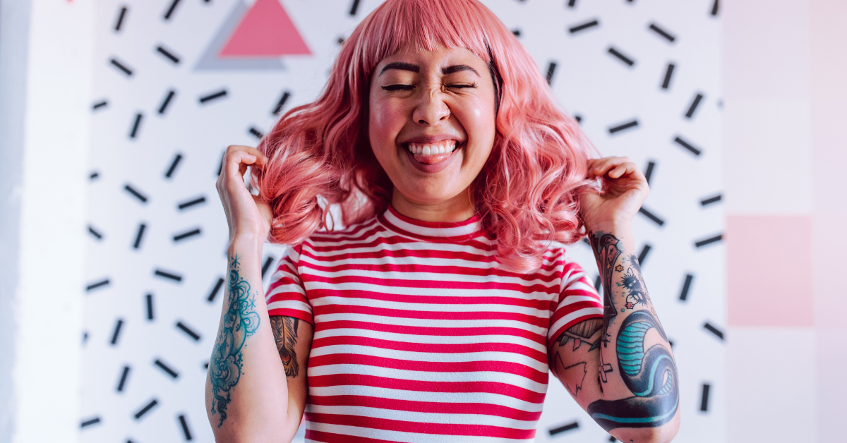 a woman having fun with a pink wig
