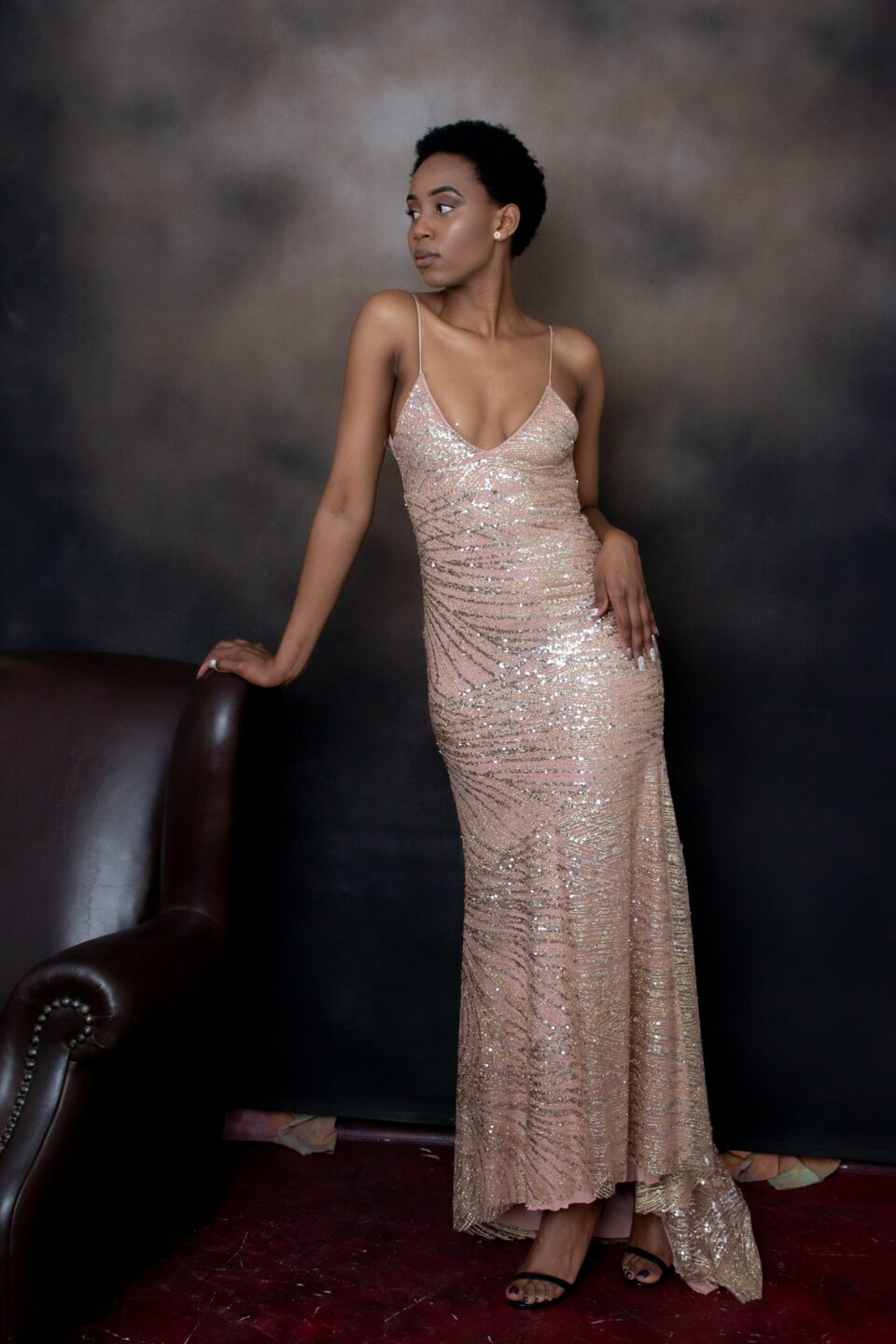 sequinned pink dress being worn by a tall slim black model
