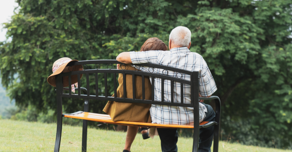 2 senior citizens sitting on a bench