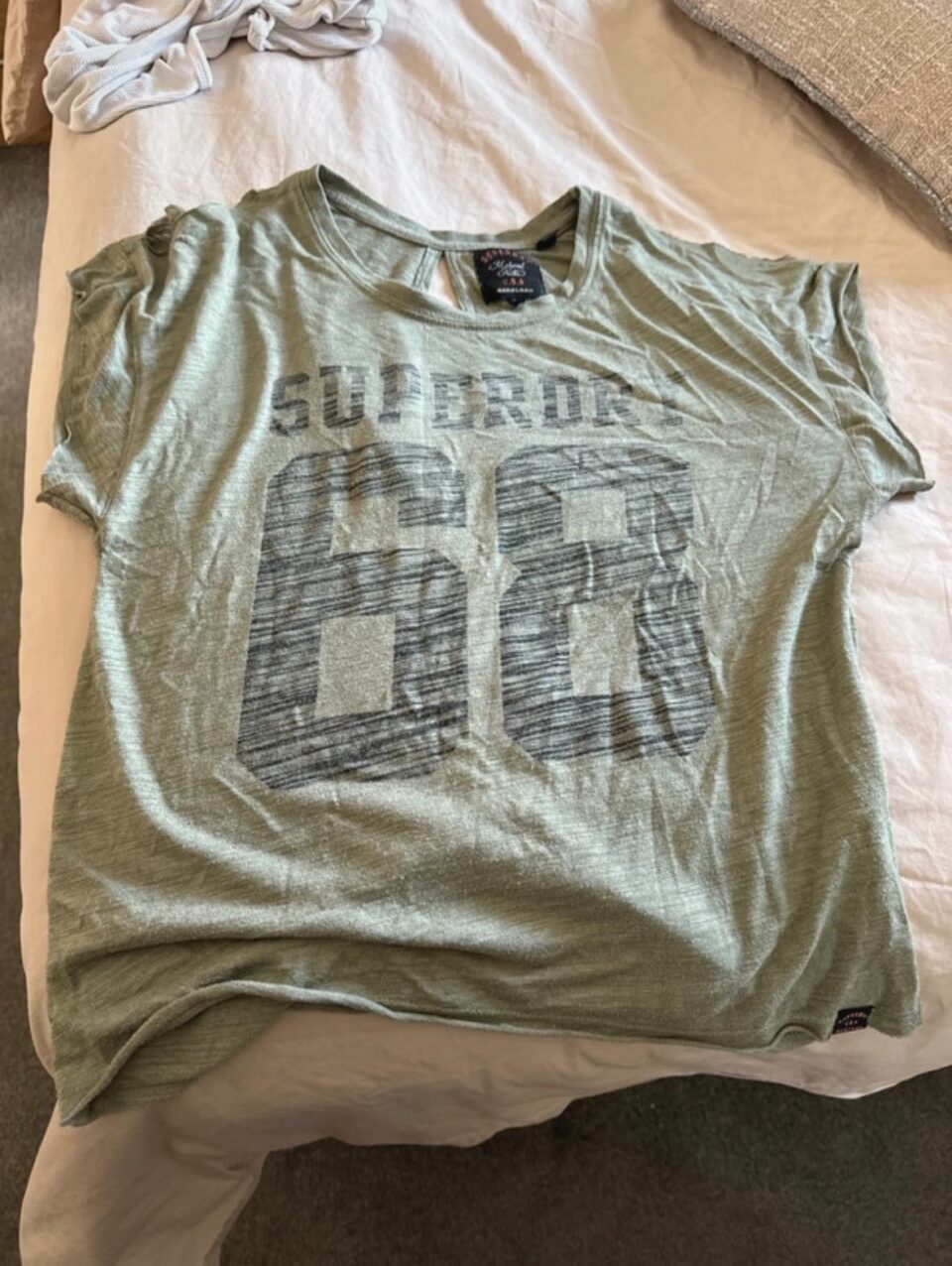 a very wrinkled t shirt being sold on vinted 