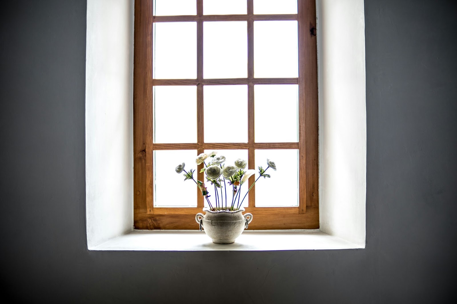 a wooden window with flowers in it