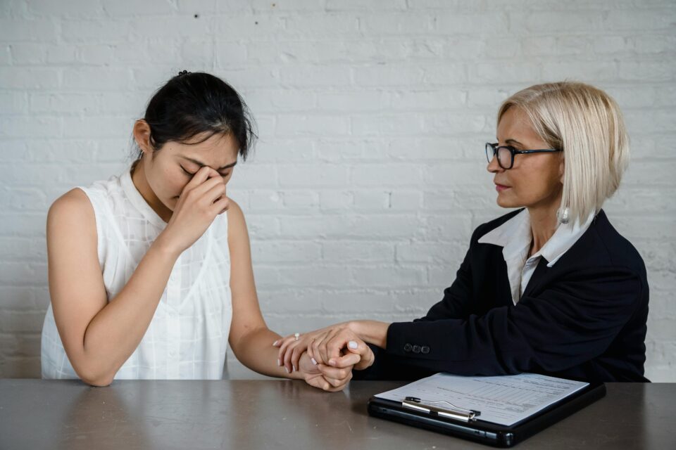 a woman being consoled by another woman