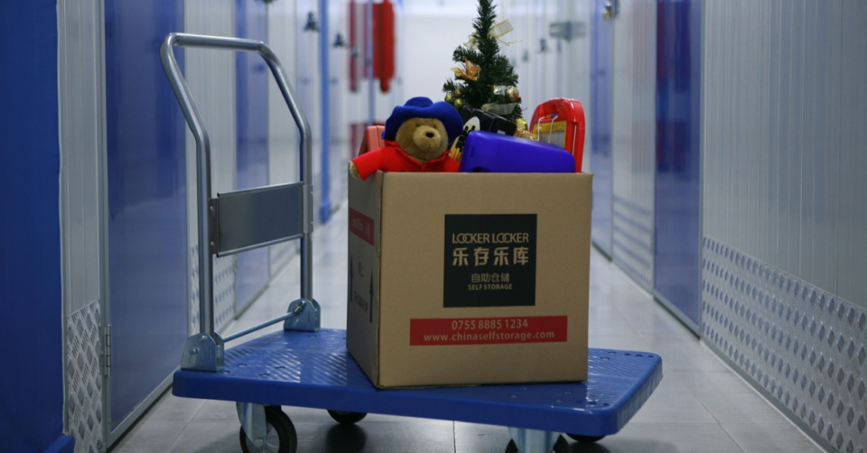 storage units and a trolley with a box of child's belongings in it