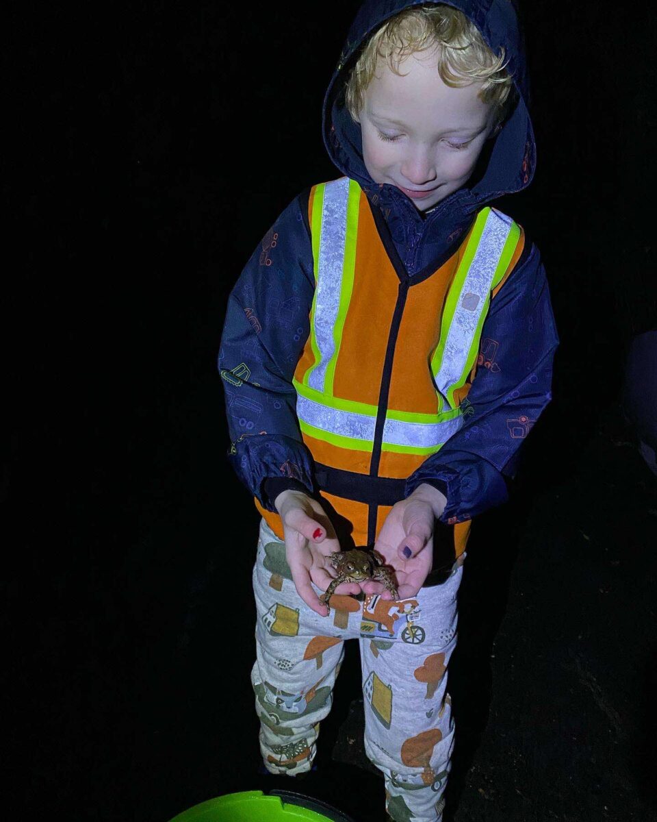 child holding a toad