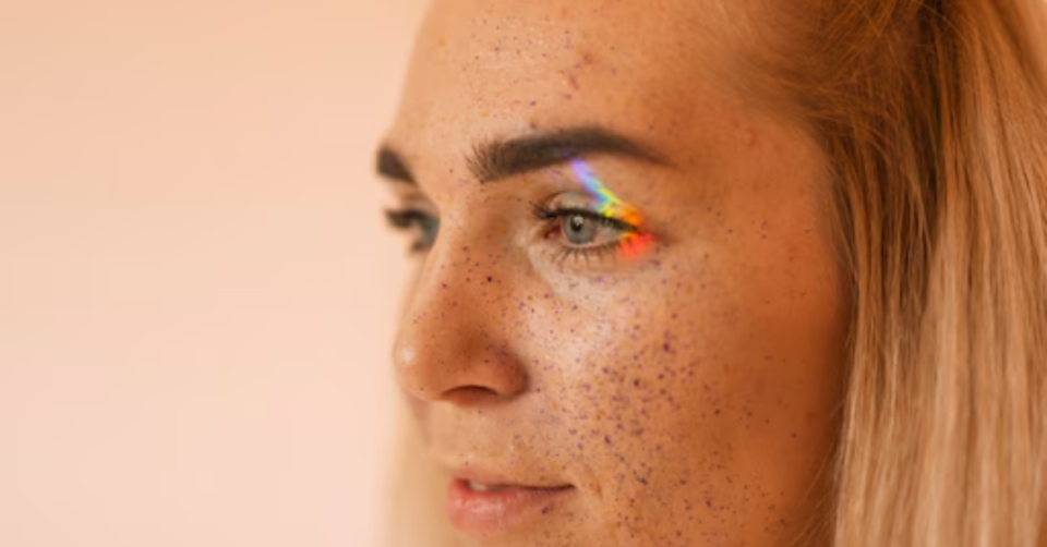 a girl with arainbow on her eye