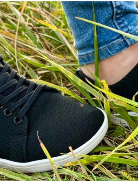 Feelgrounds black and white shoes show in a field