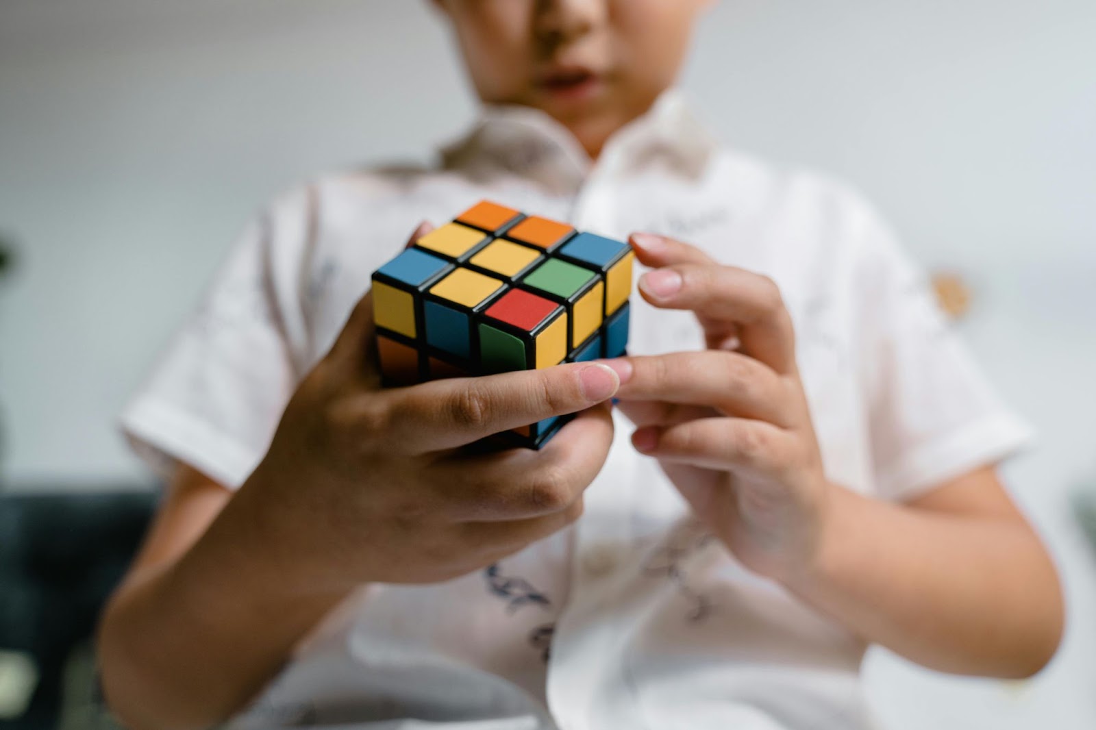 a child doing a rubix cube