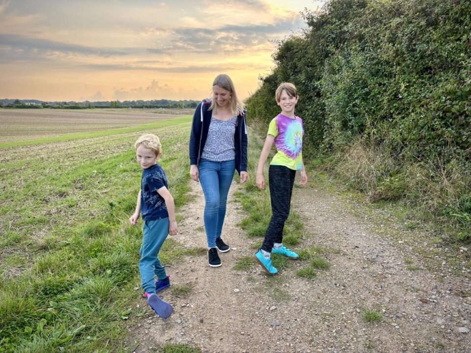 all three of us wearing our Feelgrounds shoes in afield with a sunset in the background