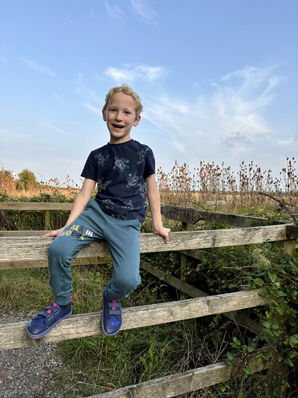 William sat on a fence wearing his Feelgrounds shoes