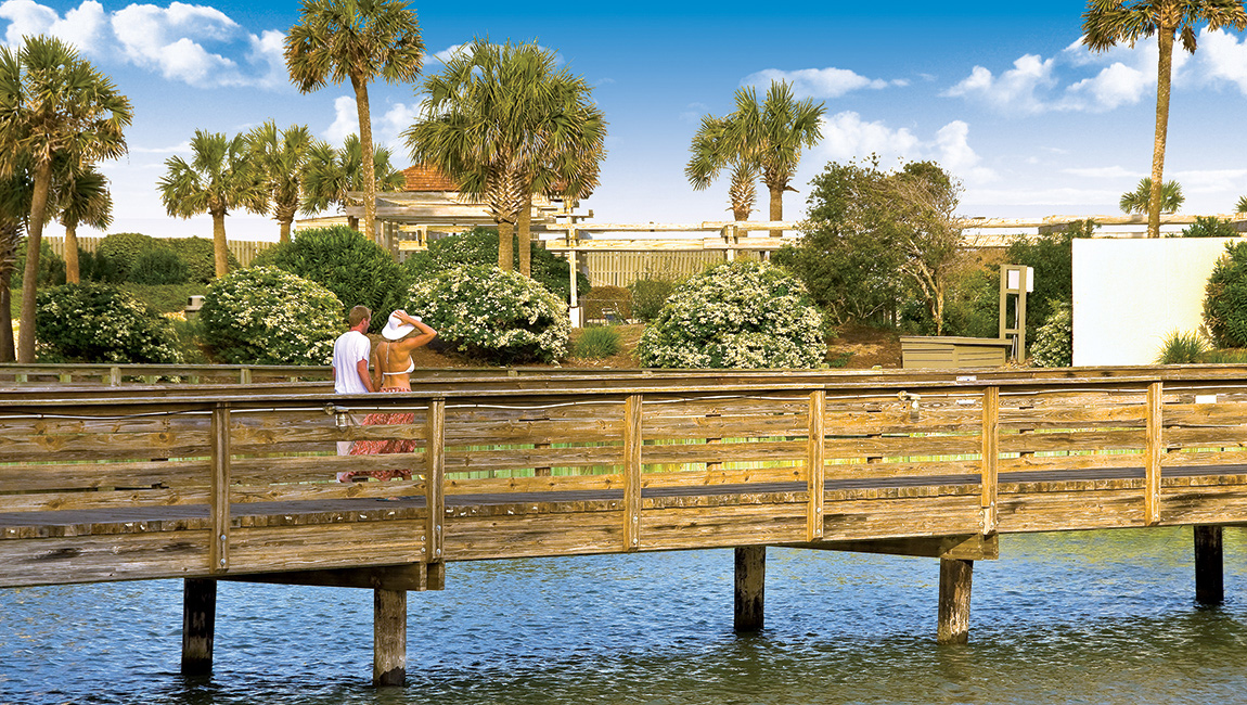 a couple on a boardwalk