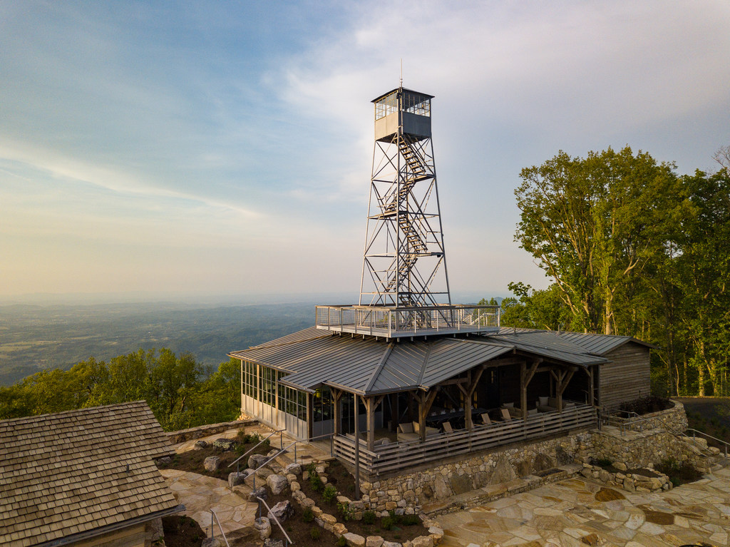 unusual cabin with a lookout tower on the roof