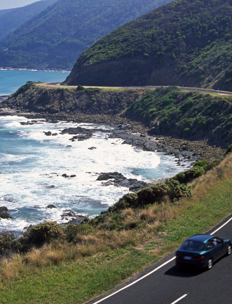 car on a road near the coast