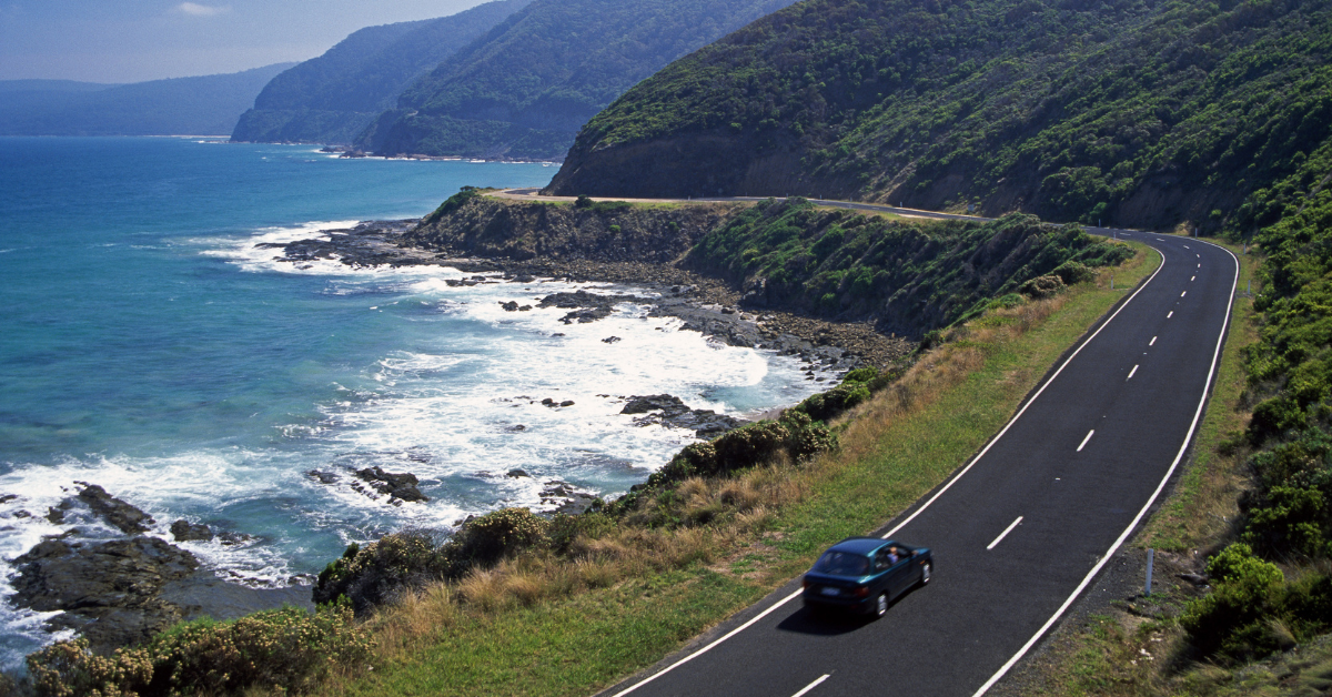 car on a road near the coast