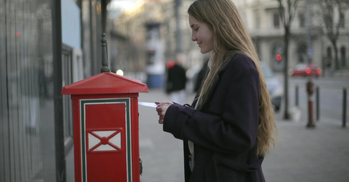 a woman at a mailbox