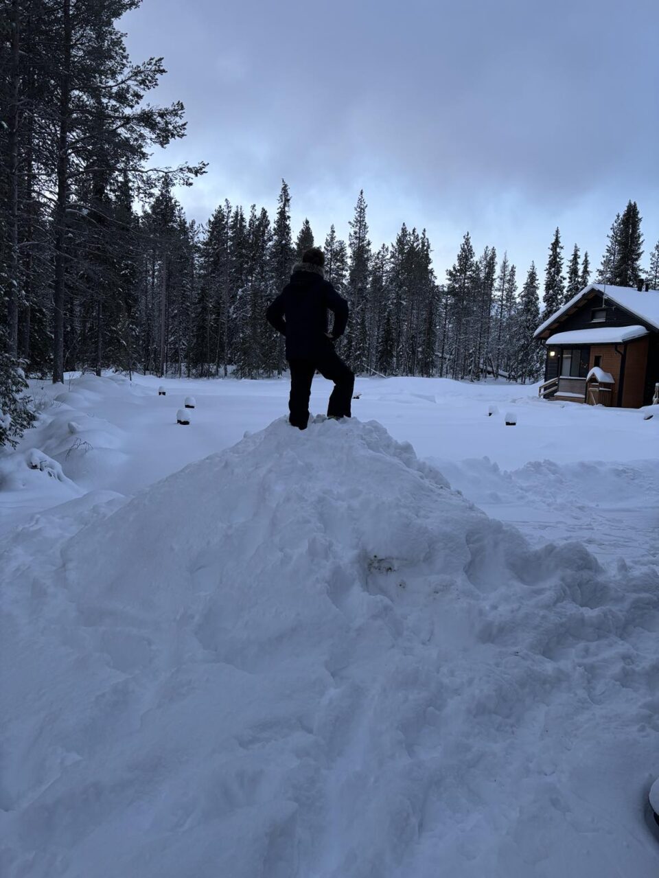 child on top of snow pile