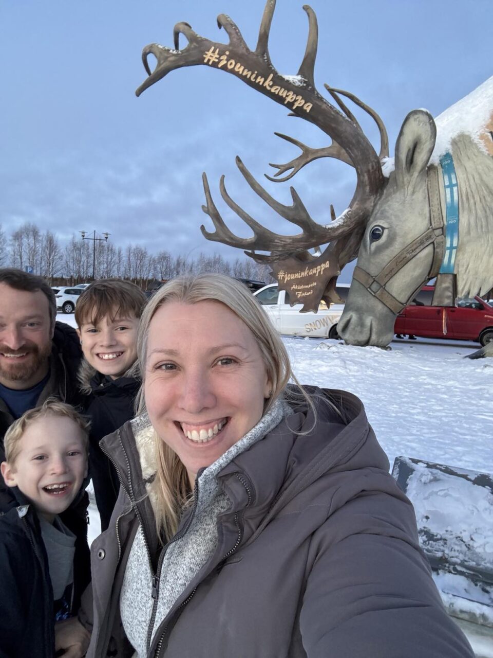 a family selfie with the giant reindeer