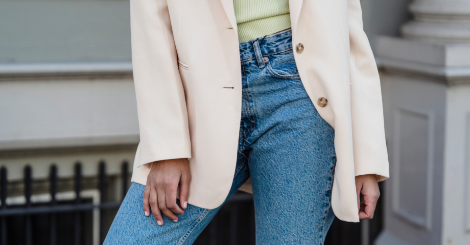 a lady wearing layering clothing with jeans, jacket and jumper