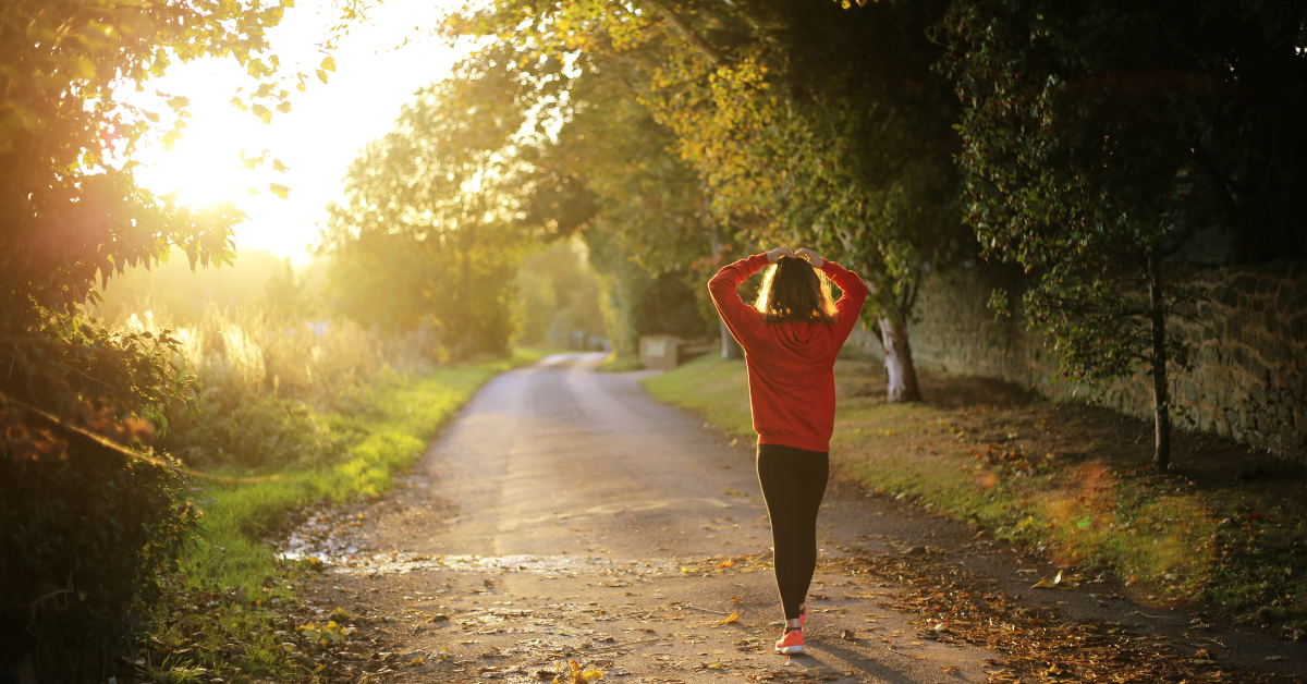 a runner taking a breather looking at the golden light