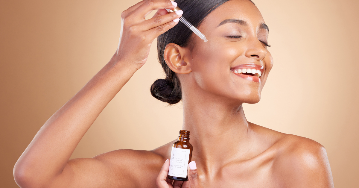 a lady applying oil to her skin