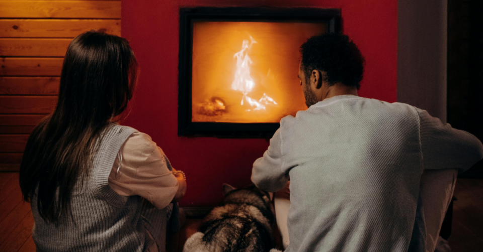 a couple by a fireplace