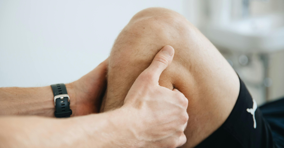 a physio checking a knee