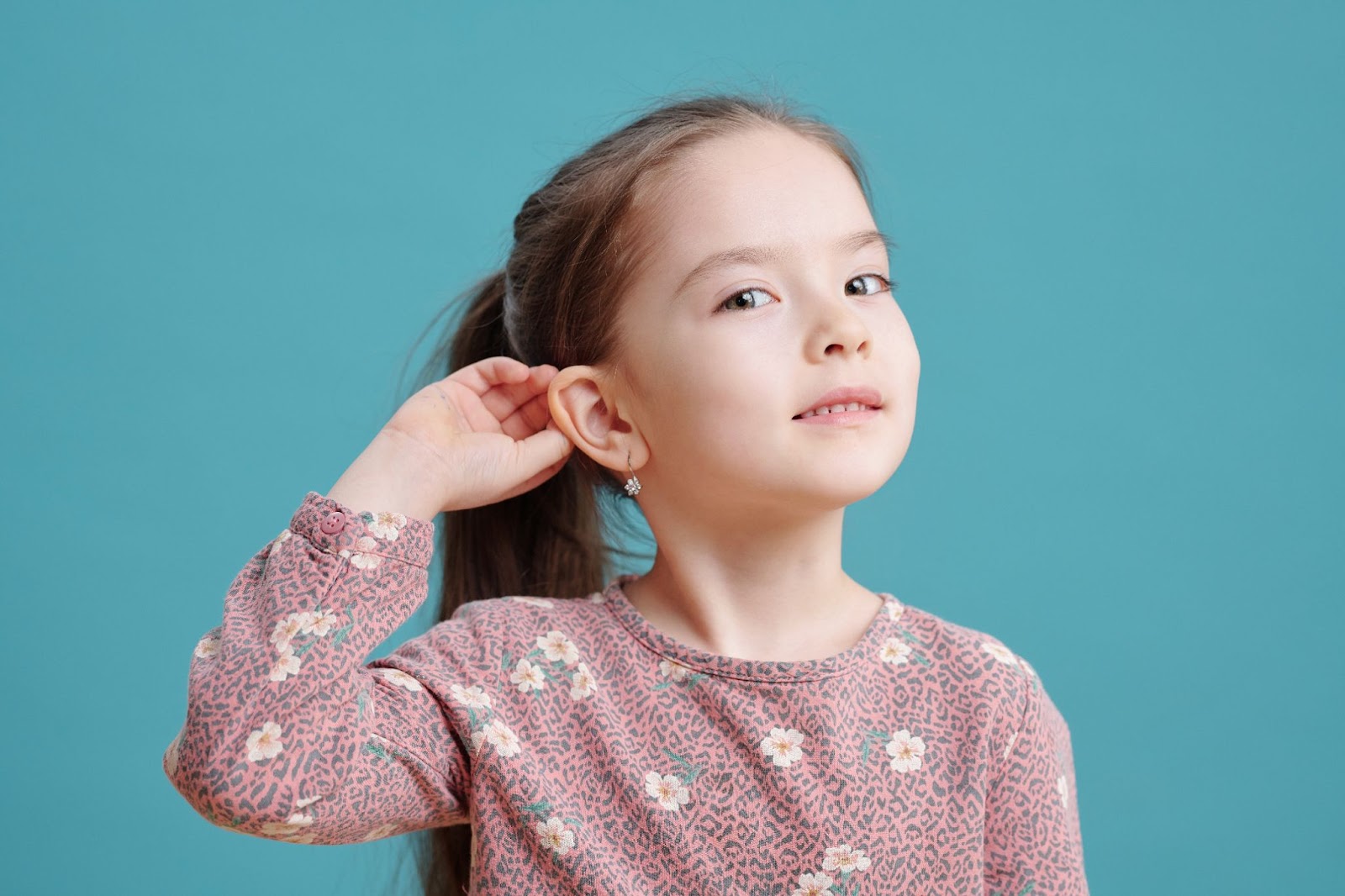 a girl showing you her earrings