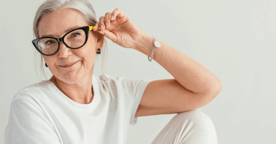 a grey haired woman wearing glasses